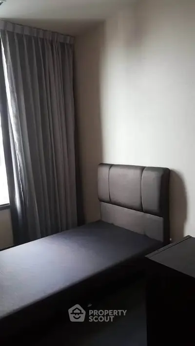 Cozy minimalist bedroom with single bed and elegant curtains