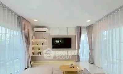 Spacious modern living room with large windows and elegant decor