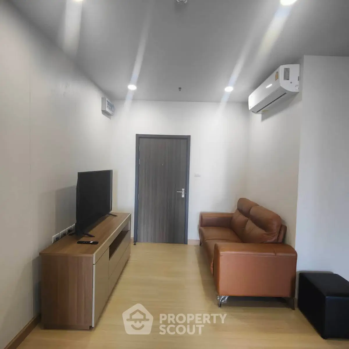 Modern living room with sleek furniture and air conditioning