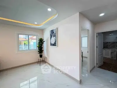 Modern interior with elegant lighting and glossy flooring, featuring a stylish plant and wall art.