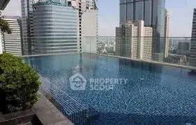 Luxurious rooftop pool with stunning city skyline views in modern high-rise building.