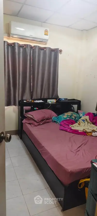 Cozy bedroom with air conditioning and simple decor, perfect for comfortable living.