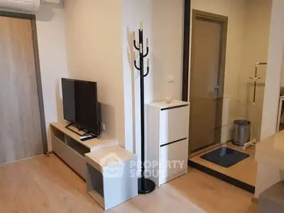 Modern apartment interior with sleek TV stand and coat rack