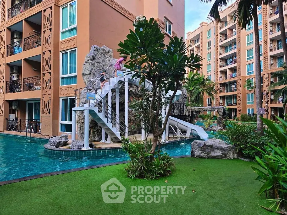 Luxurious apartment complex with stunning pool and lush greenery