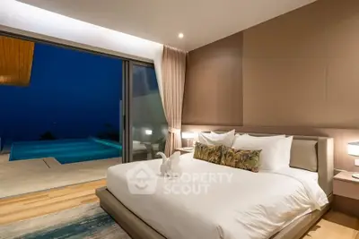Luxurious bedroom with pool view in modern villa, featuring elegant decor and ambient lighting.