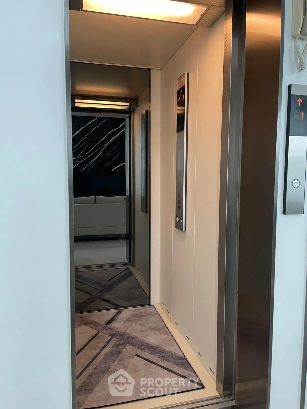 Modern elevator interior with sleek design and stylish flooring in a luxury building.