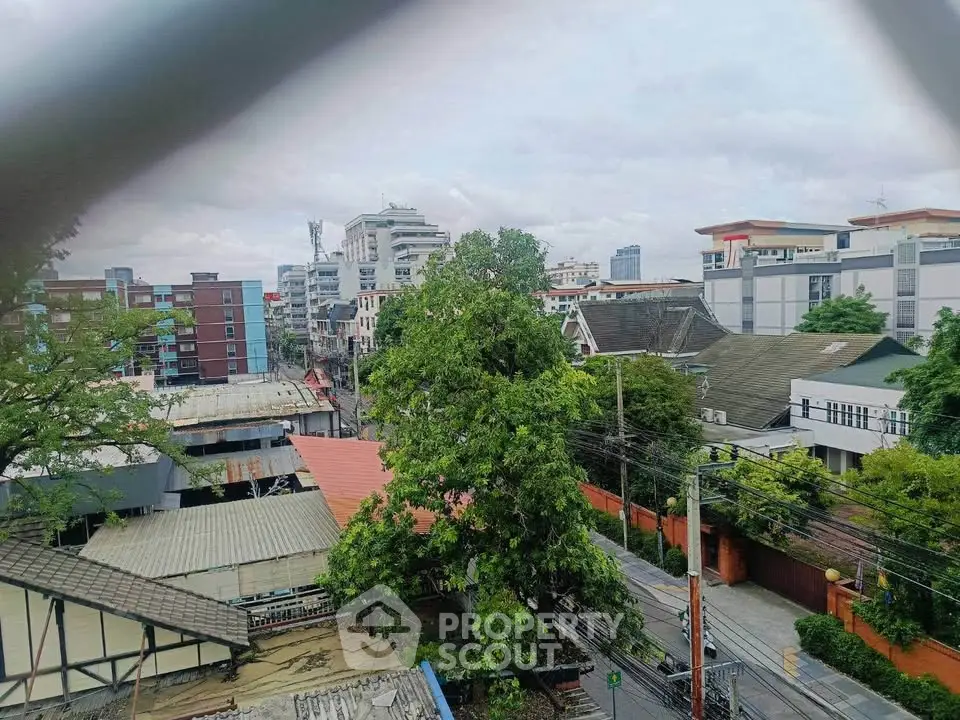 Scenic urban view with lush greenery and modern buildings, ideal for city living enthusiasts.