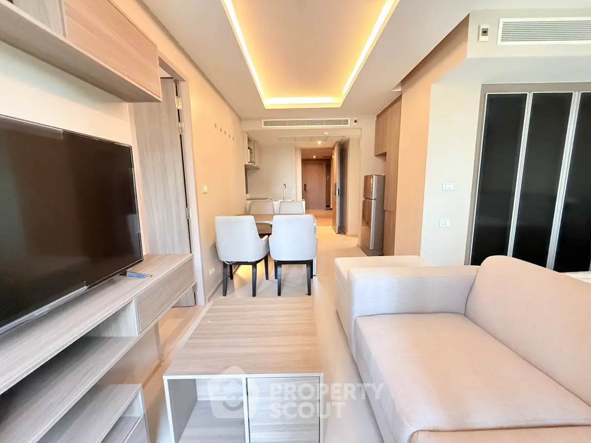 Modern living room with sleek furniture and ambient lighting in a stylish apartment.
