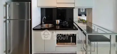 Modern compact kitchen with sleek appliances and breakfast bar