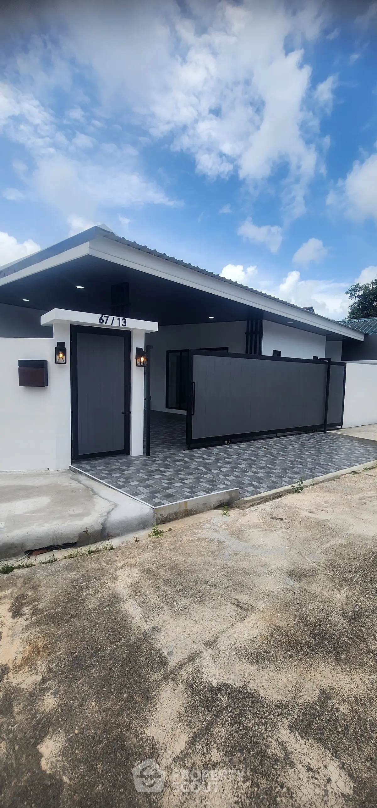 Modern single-story home with sleek black gate and spacious driveway.
