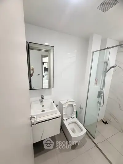 Modern bathroom with sleek fixtures and glass shower enclosure