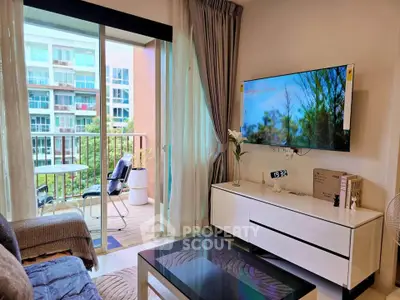 Modern living room with balcony view, sleek furniture, and wall-mounted TV in a stylish apartment.