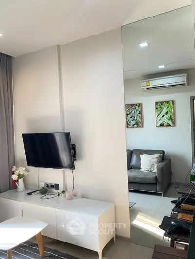 Modern living room with sleek TV setup and cozy seating area