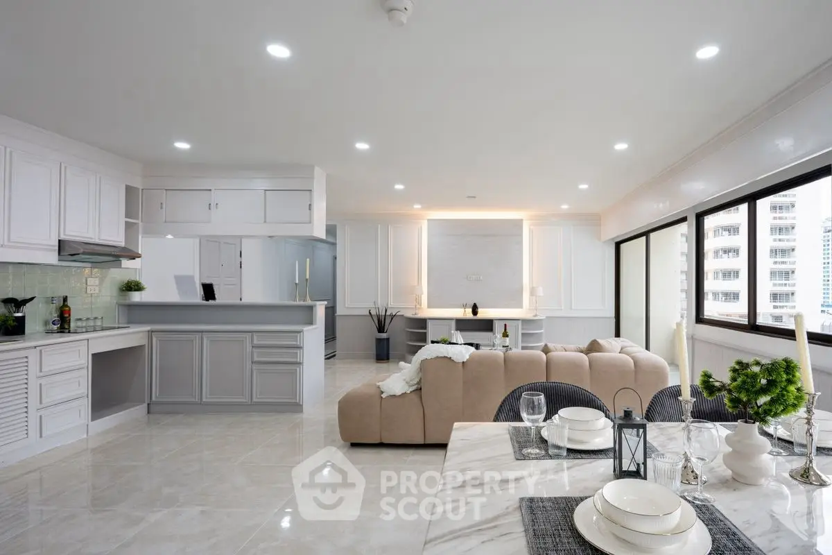 Spacious open-plan living room with modern kitchen and elegant dining area