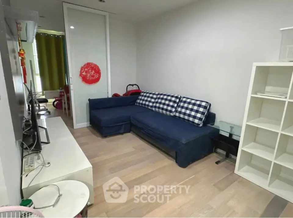 Cozy living room with modern decor and comfortable seating in a stylish apartment.