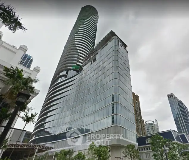 Stunning modern high-rise building with sleek glass facade in urban setting.