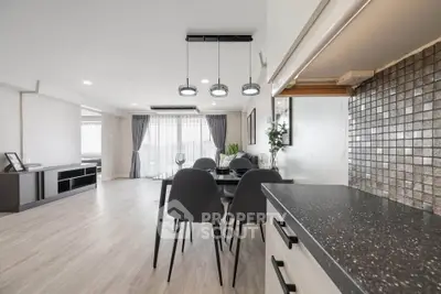 Spacious modern living and dining area with sleek design and ample natural light.