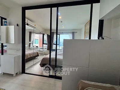 Modern bedroom with mirrored sliding doors and natural light