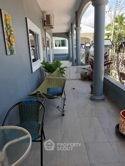 Charming balcony with hammock and potted plants, perfect for relaxation and enjoying outdoor views.