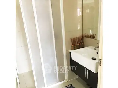 Modern bathroom with sleek shower and stylish sink in a contemporary home.