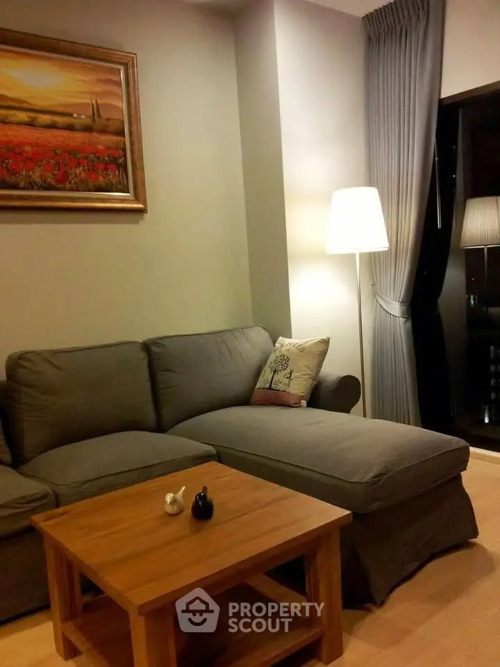 Cozy living room with modern gray sofa and warm lighting, perfect for relaxation.