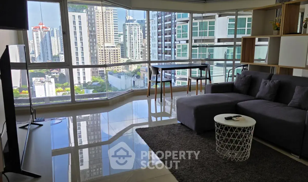Spacious modern living room with panoramic city views and sleek furnishings.
