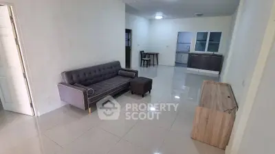 Spacious living room with modern sofa and open kitchen layout