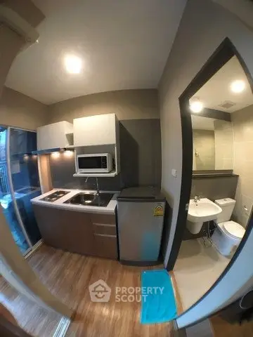 Modern compact kitchen with open layout and adjacent bathroom