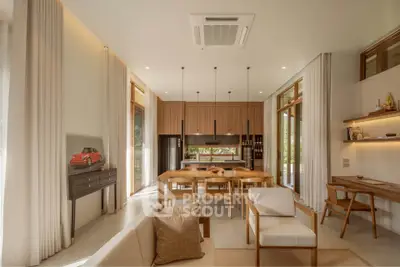Luxurious open-plan living and dining area with modern decor and natural light.