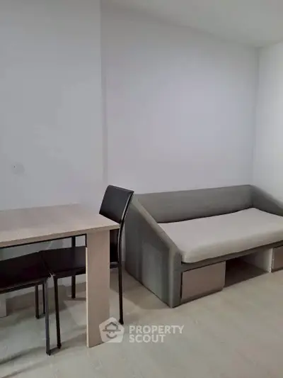 Modern minimalist living room with sleek furniture and neutral tones.