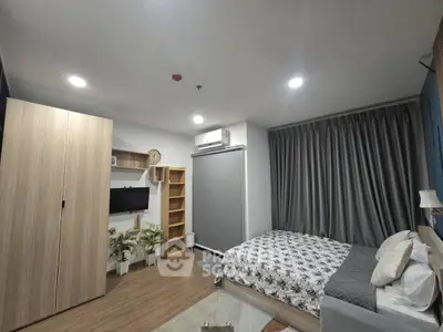 Modern bedroom with stylish decor, featuring a cozy bed, wooden wardrobe, and sleek air conditioning unit.