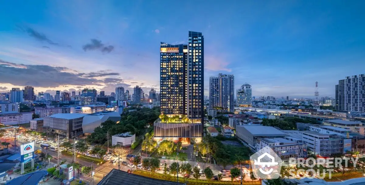 Stunning cityscape view of modern high-rise building at dusk with vibrant skyline