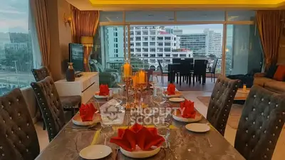 Luxurious dining and living area with elegant table setting and city view balcony.