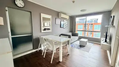 Modern living room with stylish decor, large window, and dining area in a contemporary apartment.