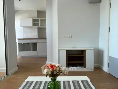 Modern apartment interior with stylish kitchen and cozy living area, featuring elegant decor and wooden flooring.