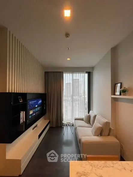 Modern living room with sleek design, featuring a wall-mounted TV and cozy sofa, perfect for urban living.