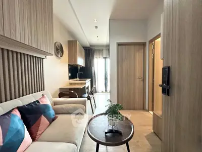 Modern living room with stylish decor and open kitchen layout in a cozy apartment.