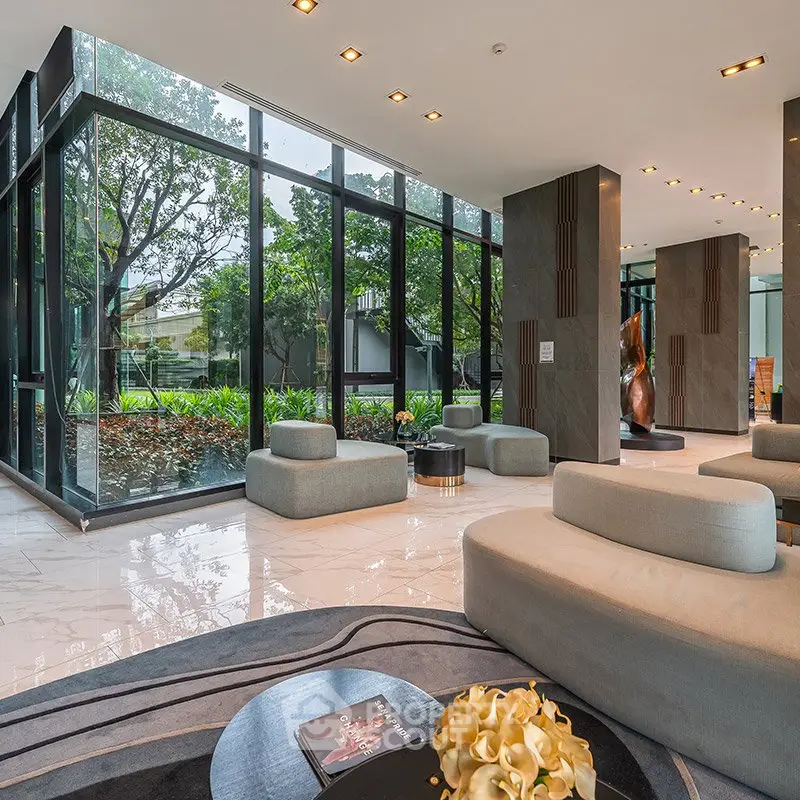 Luxurious modern living room with large windows and elegant furniture.