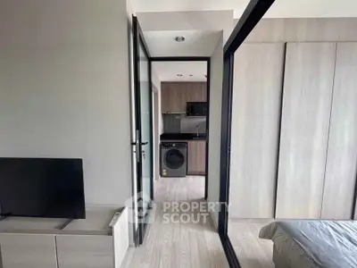 Modern apartment interior with sleek kitchen and cozy bedroom