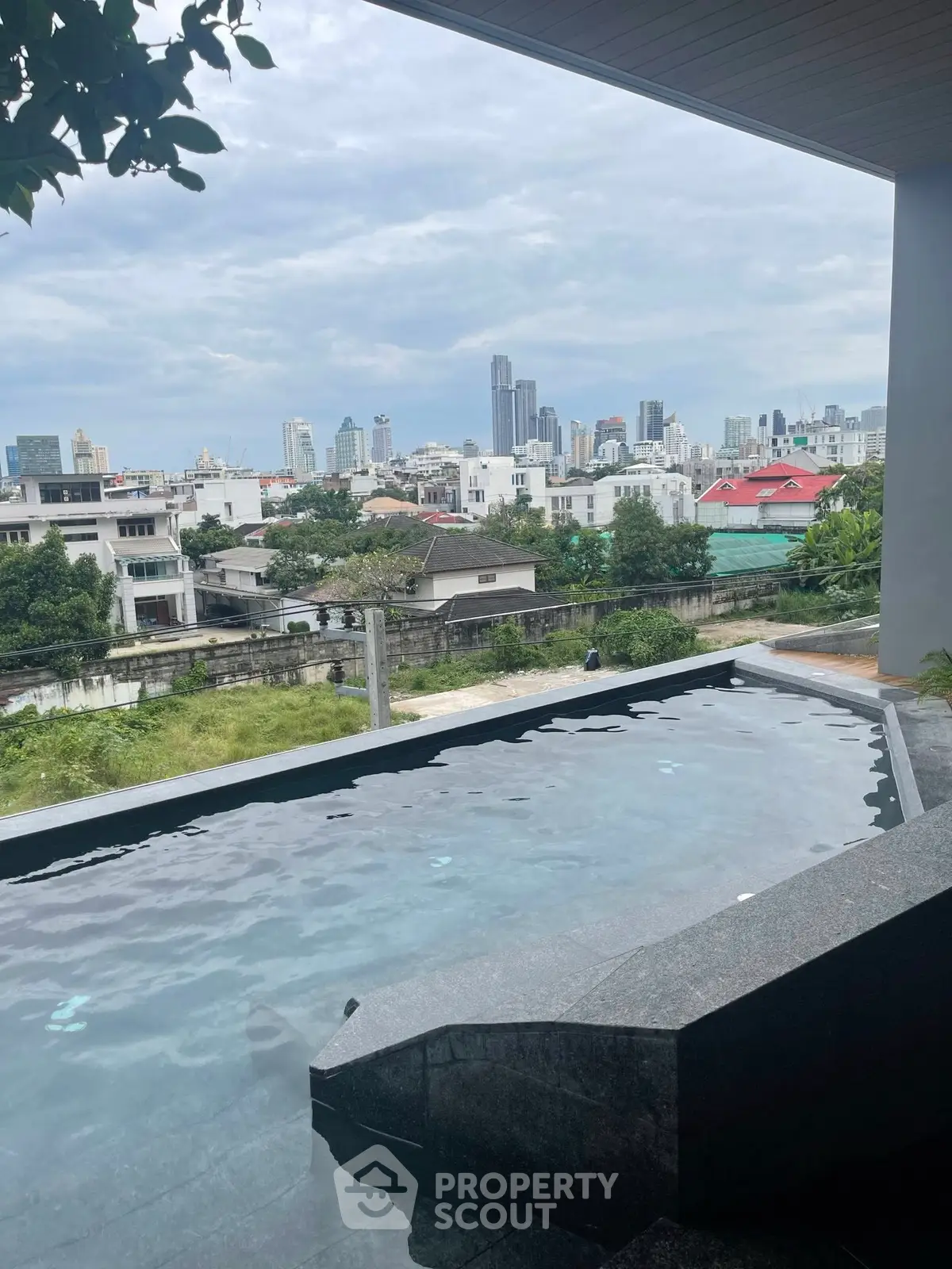 Stunning rooftop pool with panoramic city skyline view, perfect for urban living.