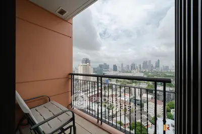 Stunning cityscape view from a modern balcony in a high-rise apartment.