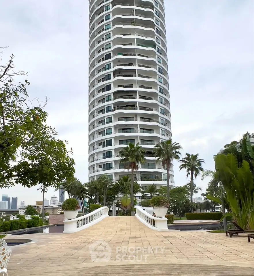 Stunning high-rise building with lush landscaping and elegant entrance pathway.