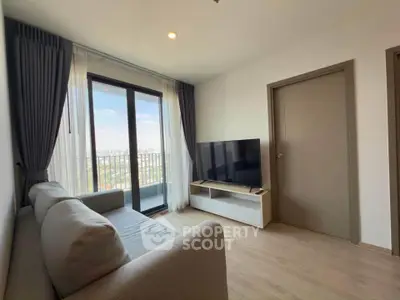 Modern living room with large window and city view, featuring a sleek sofa and flat-screen TV.
