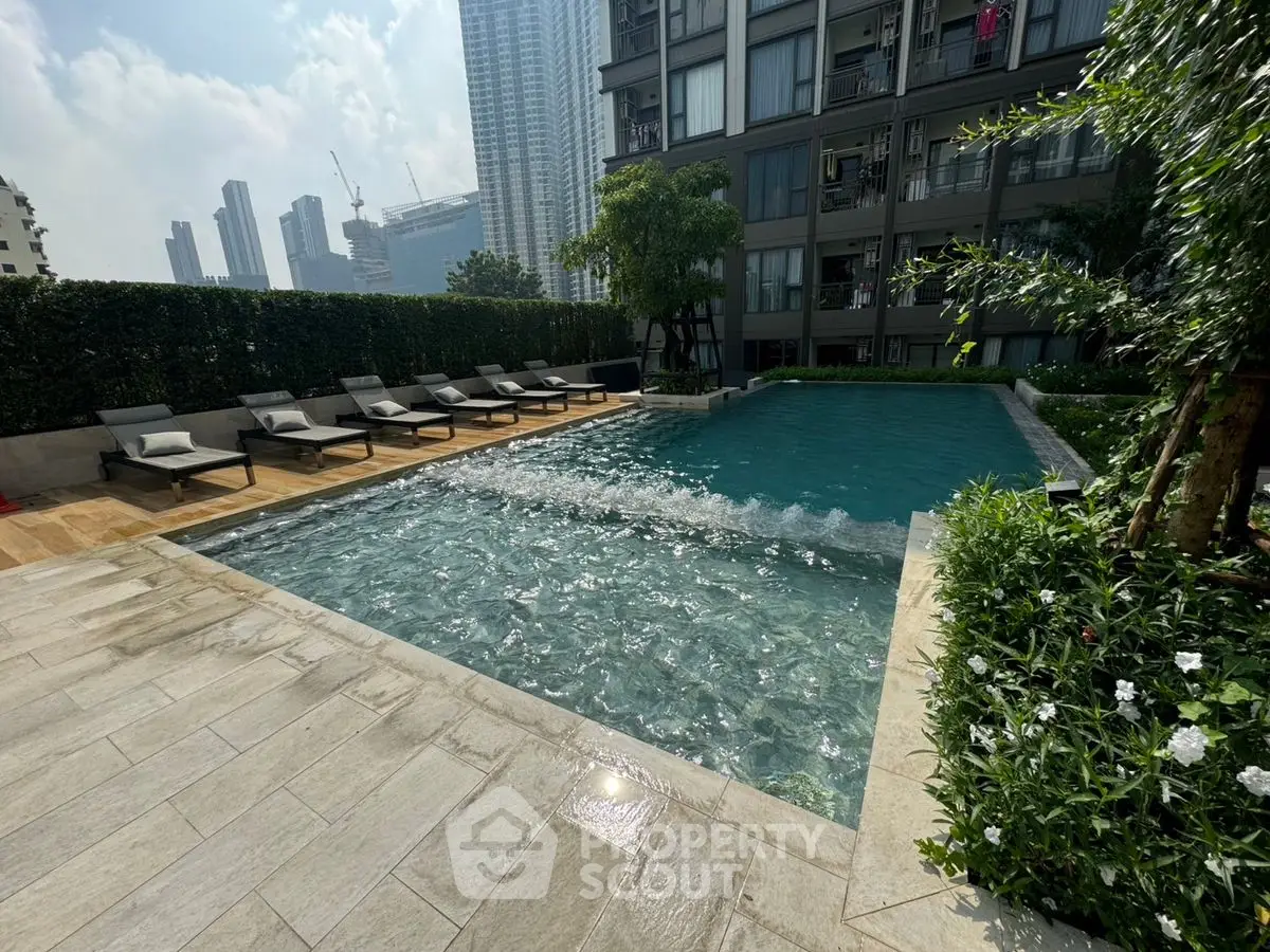 Luxurious urban poolside with skyline view and modern amenities.