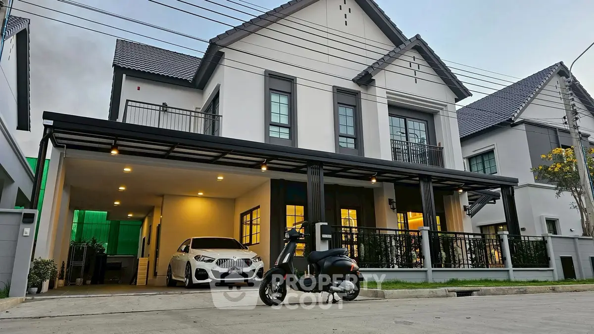 Modern two-story house with carport and scooter parked outside, showcasing contemporary architecture.