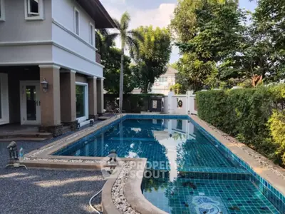 Luxurious home with private swimming pool and lush greenery in serene setting