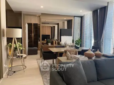 Modern living room with stylish decor, large windows, and elegant furniture in a contemporary apartment.