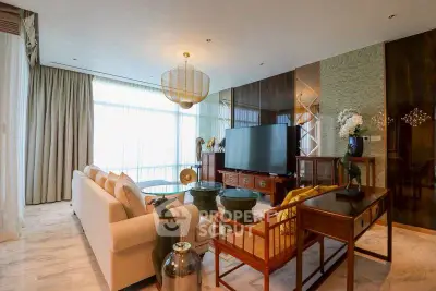 Luxurious living room with elegant decor and large TV, featuring floor-to-ceiling windows and stylish furniture.