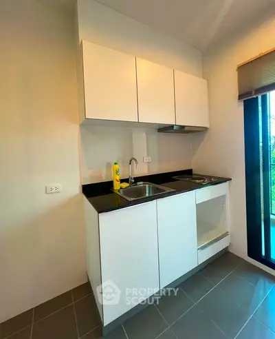 Modern kitchen with sleek cabinetry and large window view