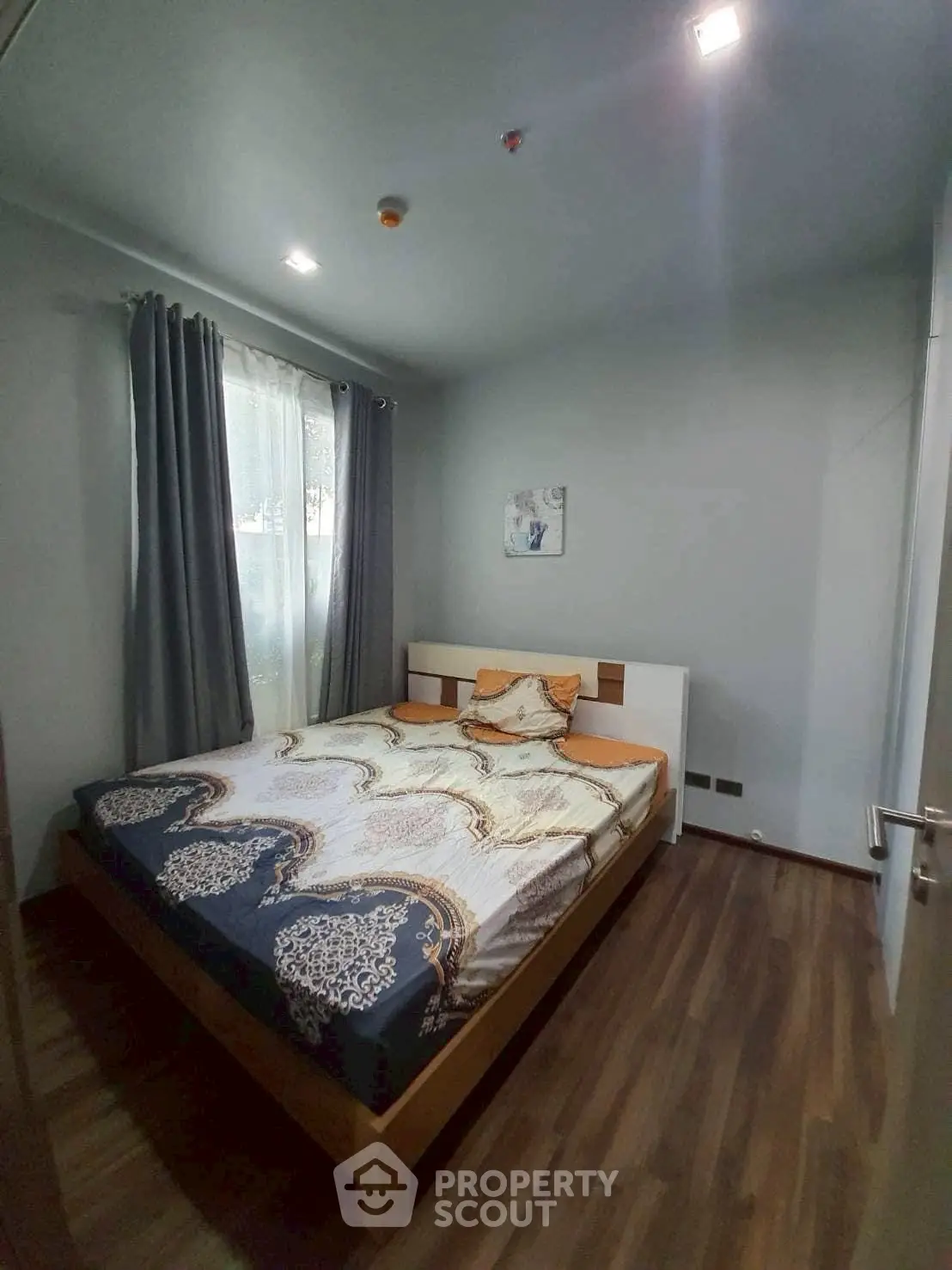 Cozy bedroom with modern decor and wooden flooring